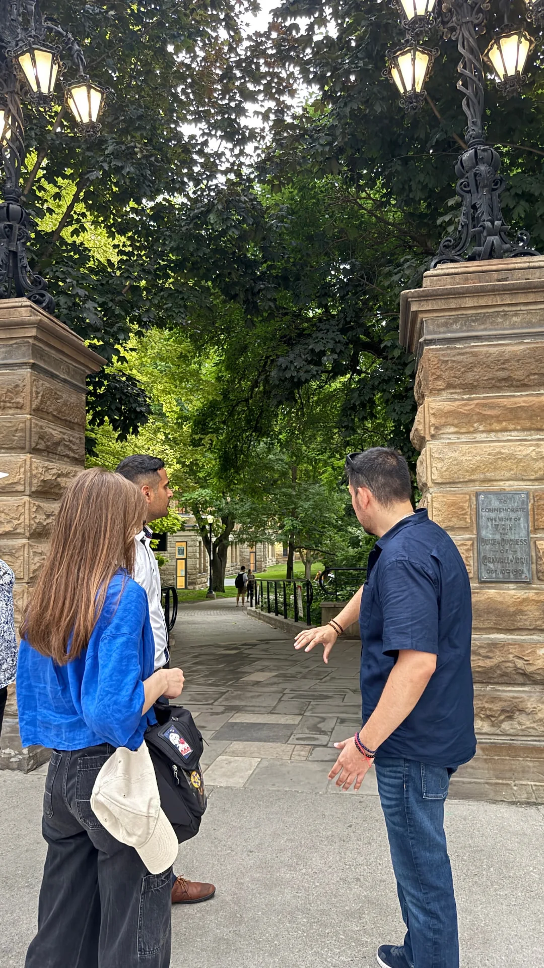 Mike guiding guests beside the stone and iron gates at Philosopher's Walk in Toronto
