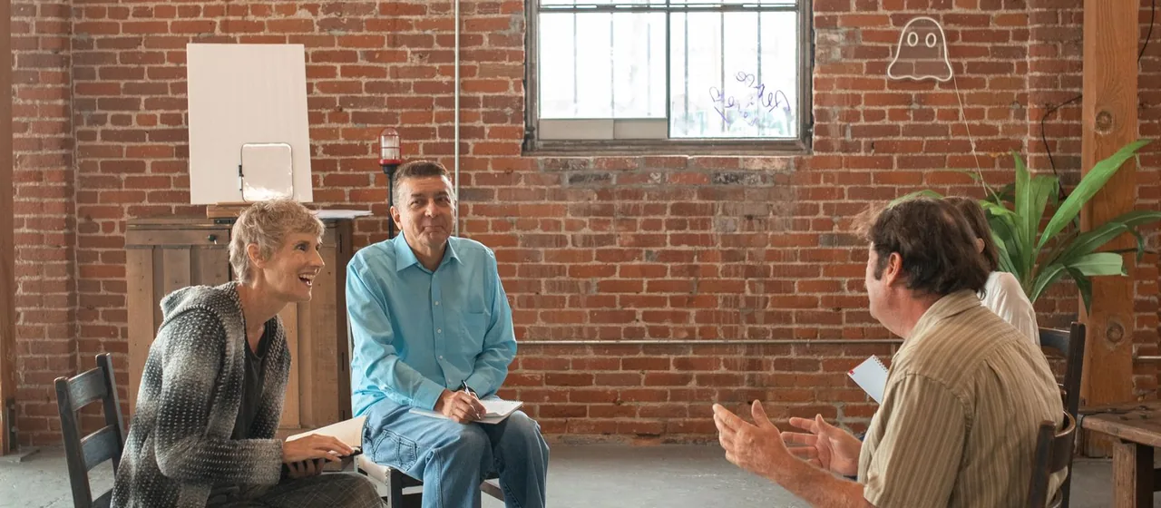 Adults participating in a small-group learning discussion